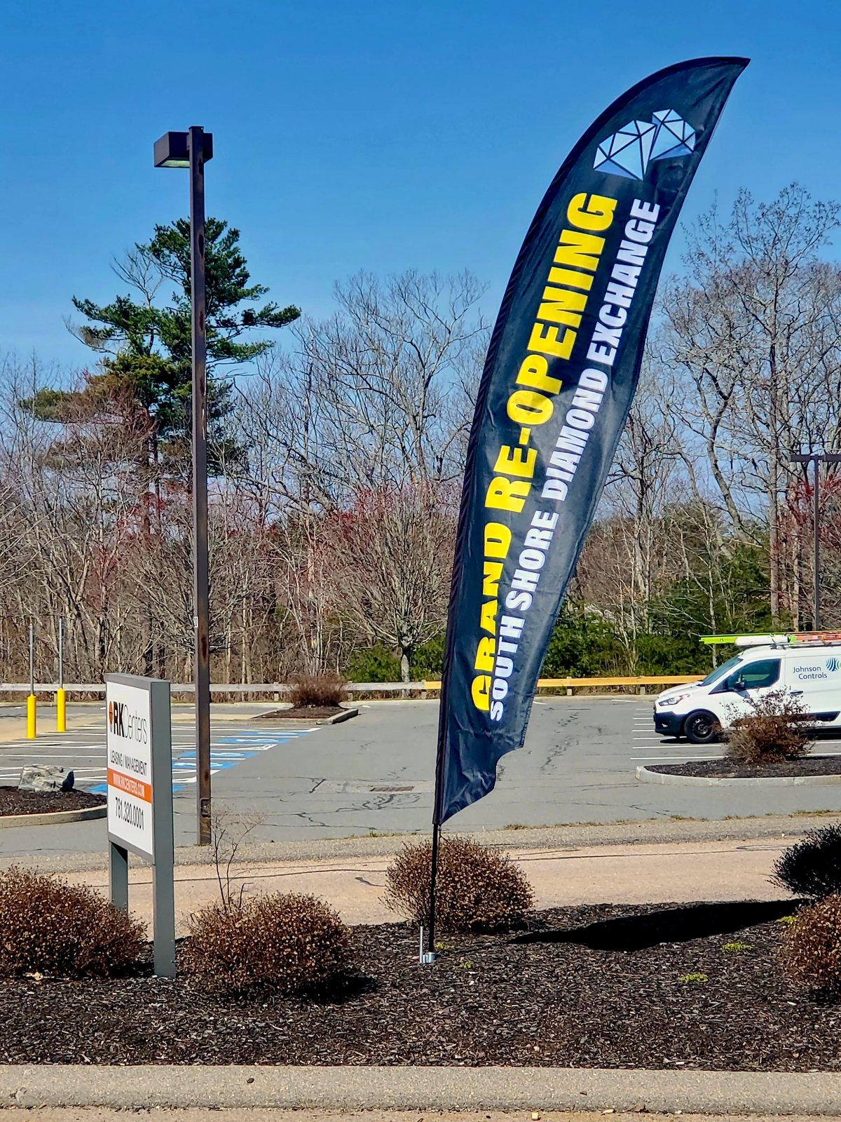 Feather flag announcing a grand re-opening