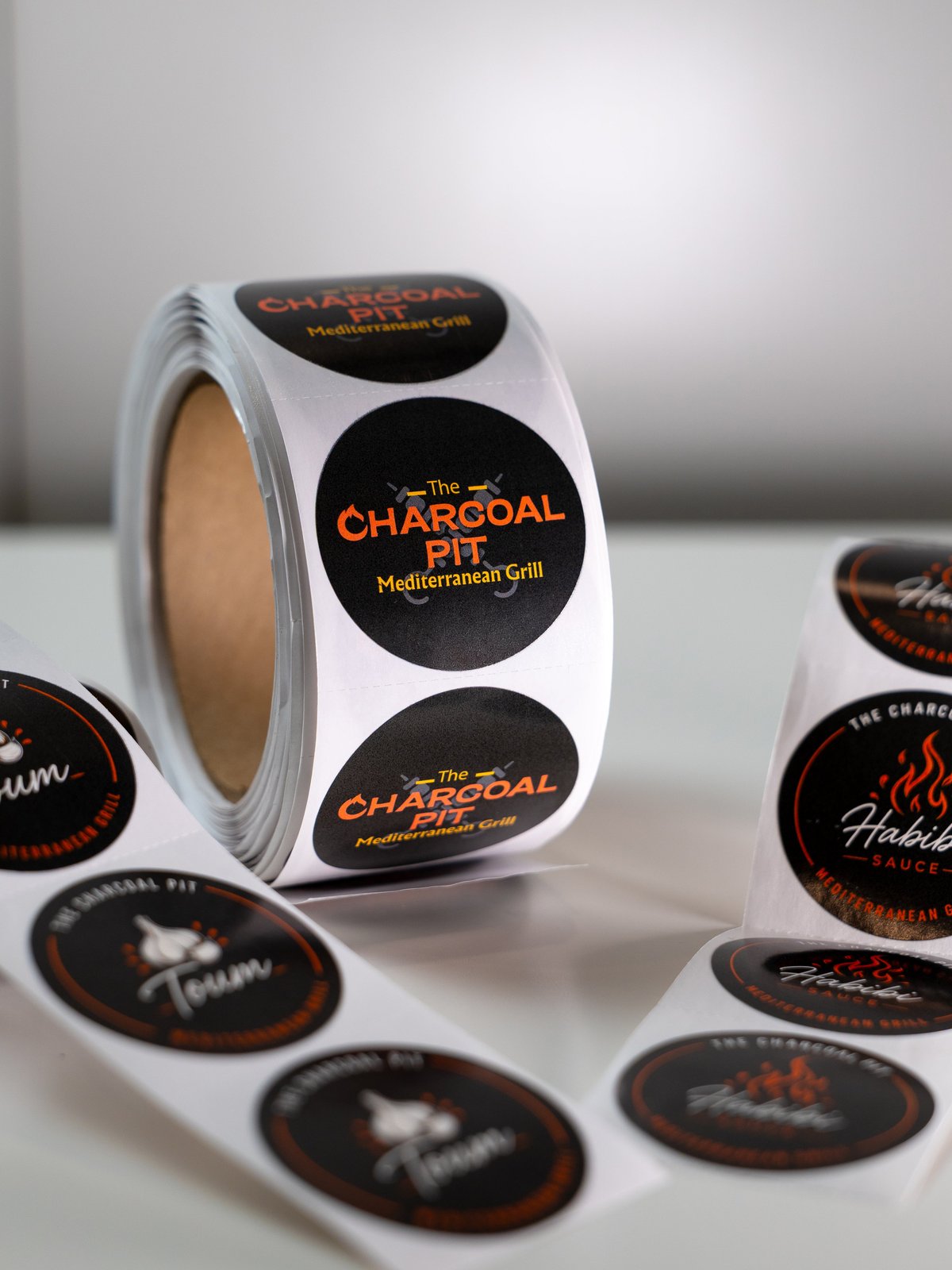 Roll of custom circle labels printed for The Charcoal Pit