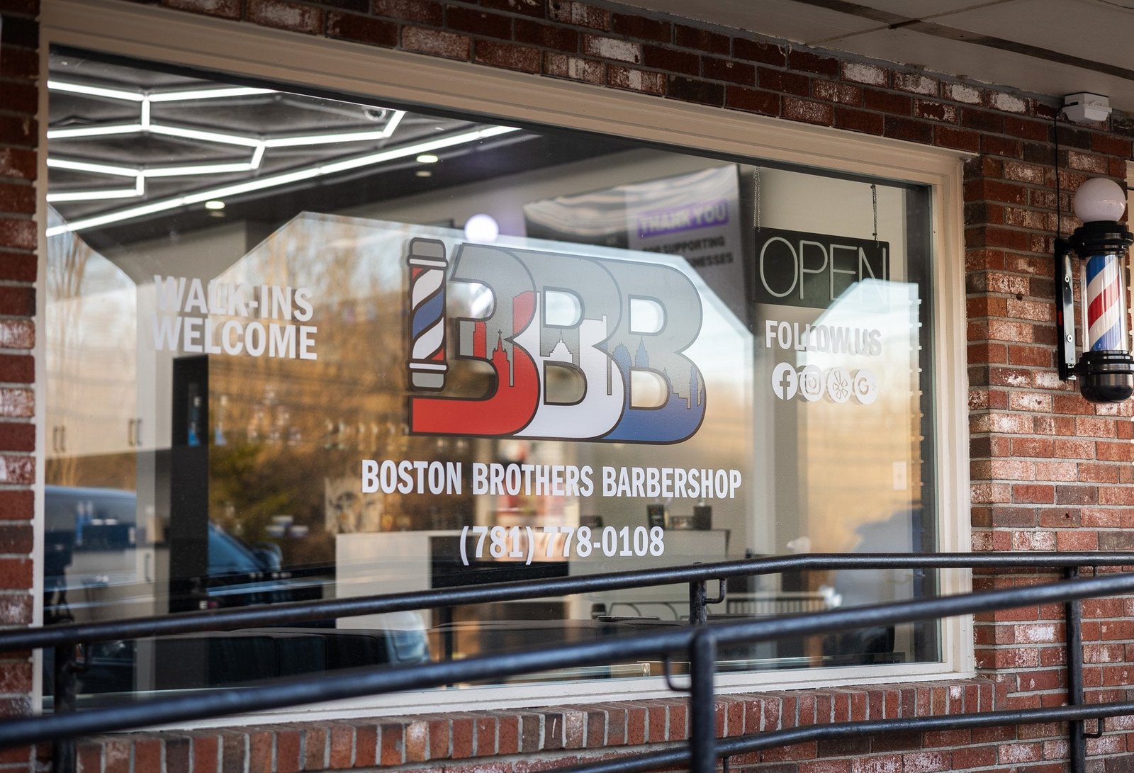 Window graphics installed on a barbershop storefront