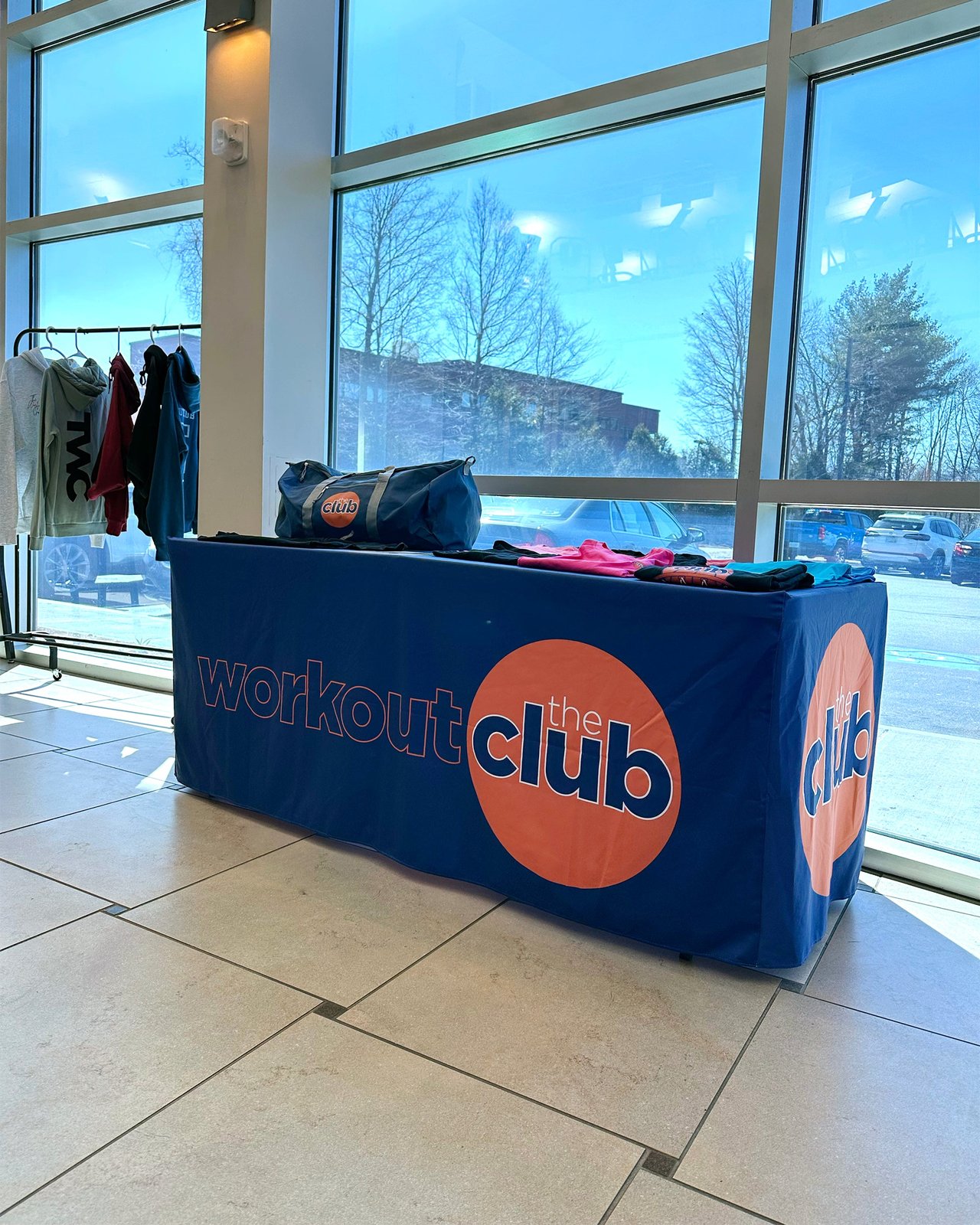 Fitted table cover with a printed logo by a window
