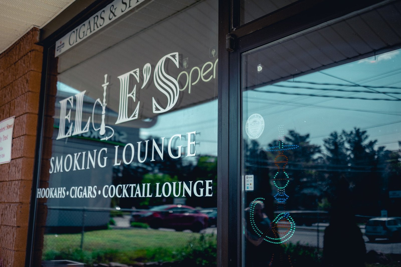 Window graphics on a cigar lounge storefront