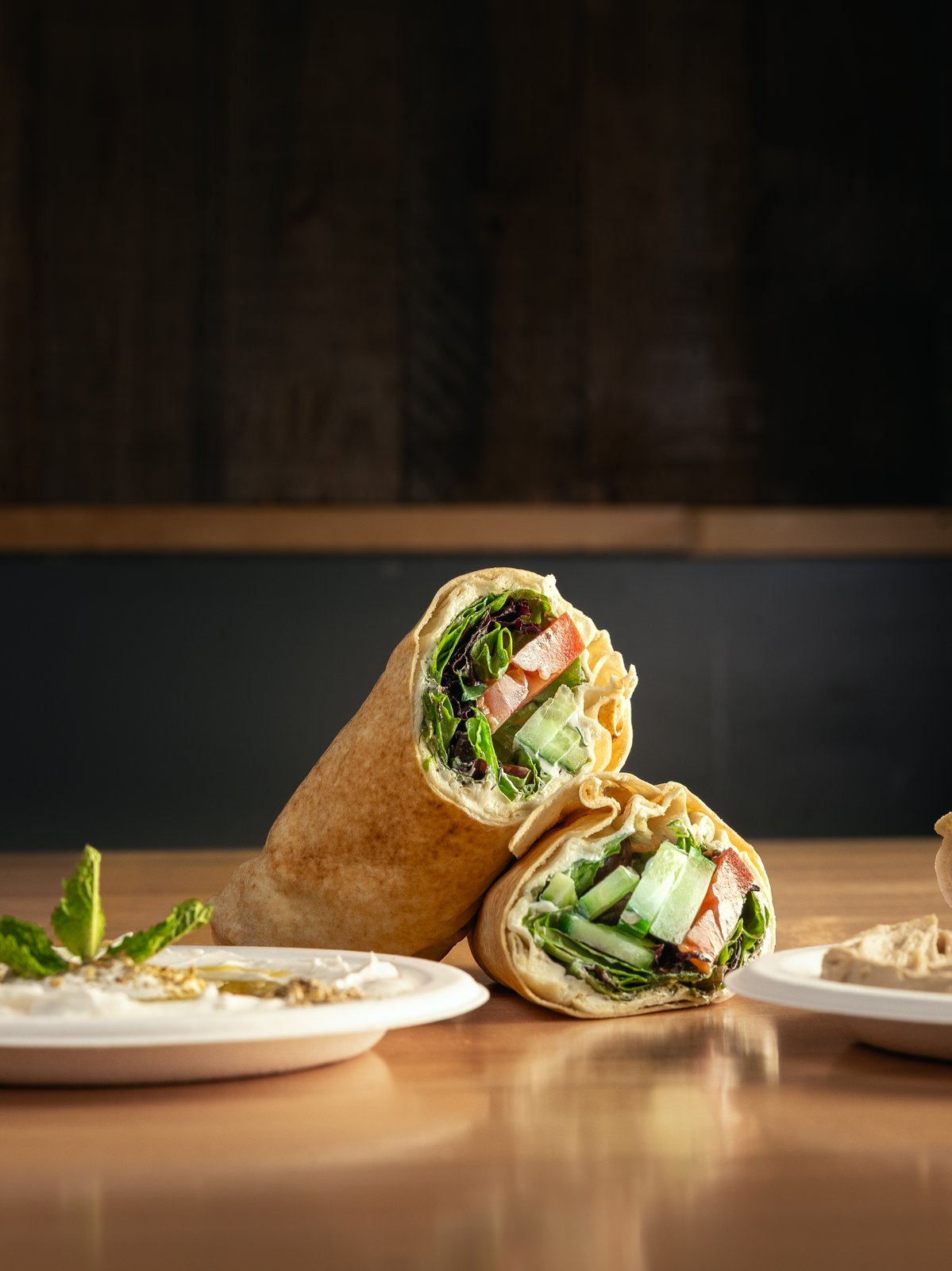 Wraps on a dark table, food photography for Pita Thyme
