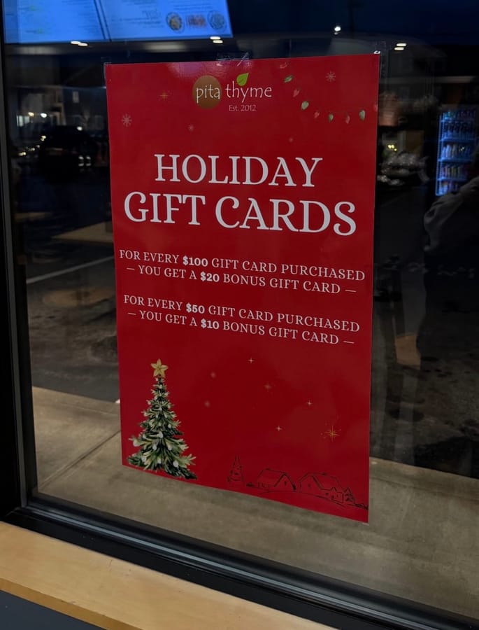 Holiday gift cards poster in a store window