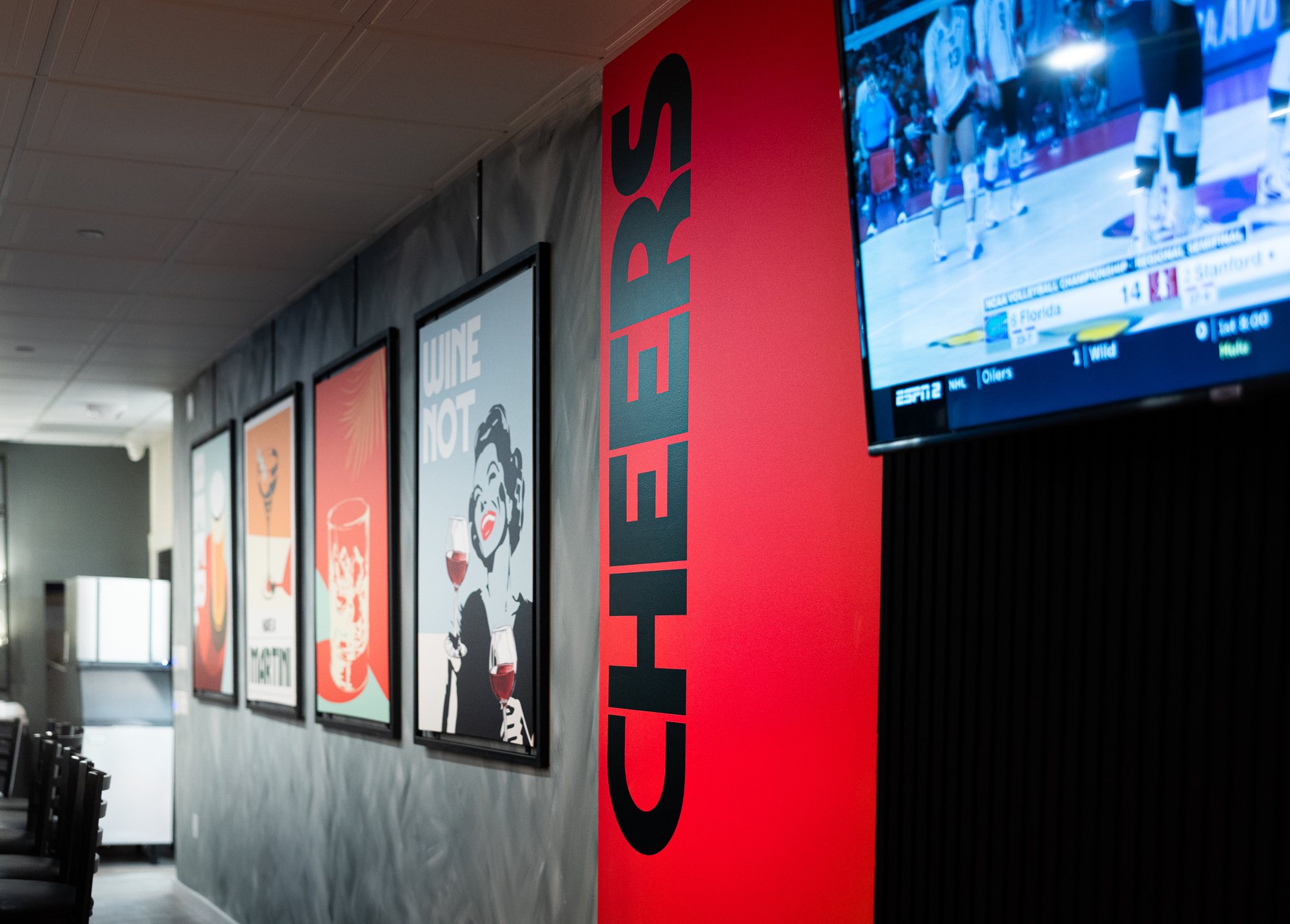 Giant CHEERS decal on the red wall by the bar at DREO