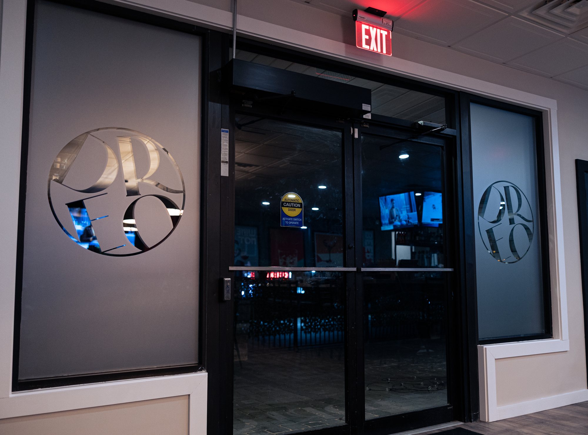 DREO entrance in Salem, NH with frosted window film and the round DREO logo cut out on both sides of the doors